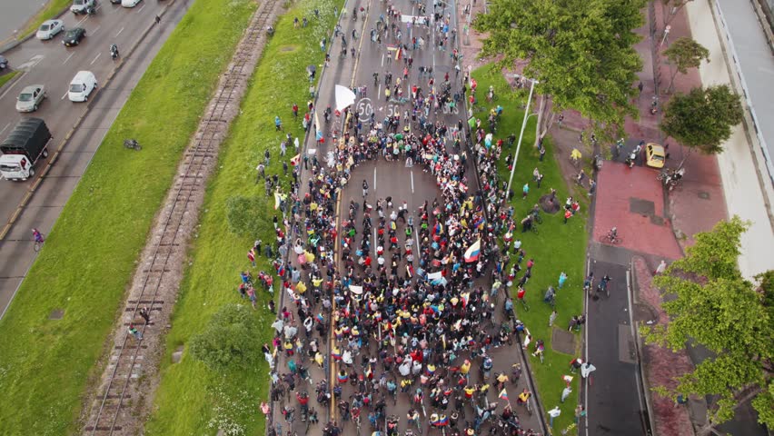 Peaceful Protest March With Drummers, Bikes and Flags in Highway, Aerial View– Bogotá, Colombia