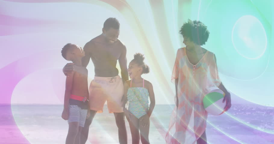 Family arriving shoreline laughing holding beach ball for resort ad with rainbow light animation. Coastal, togetherness, joyful, vibrant, casual, outdoor, bonds