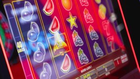 Colorful slot machine screen with spinning fruit symbols, glowing lights and winning bell icon in casino environment - Powered by Shutterstock - Get 15% off with code: PIKWIZARD15