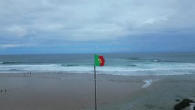 Static image of the Portuguese flag with the sea as a background at Guincho beach,Portugal - Powered by Shutterstock - Get 15% off with code: PIKWIZARD15
