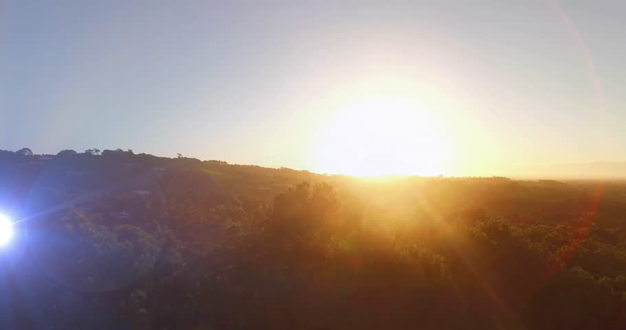 Sun rising above ridge sparking sparkles forming drifting while camera panning showing dawn view. Nature, landscape, sunrise, serenity, illumination, atmospheric, wilderness