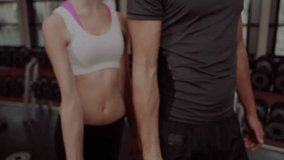 Fit woman and fit man curling dumbbells initiating financial chart overlay showing market downturn. Fitness, strength, gym, motivation, dual, healthy, dynamic - Powered by Shutterstock - Get 15% off with code: PIKWIZARD15