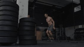 Man shifting stance jumping onto plyo box warehouse gym as overlay graphics tracking fitness stats. Strength, fitness, training, motion, performance, biomechanics, digital - Powered by Shutterstock - Get 15% off with code: PIKWIZARD15