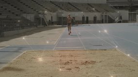 female athlete starting run accelerating toward takeoff board and landing in sandpit for long jump. Dynamic, energized, competition, outdoor, sporty, motion, athleticism - Powered by Shutterstock - Get 15% off with code: PIKWIZARD15