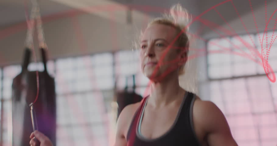 Female athlete starting jump rope in gym, with red particle trails highlighting path for fitness. Fitness, workout, athleticism, movement, vitality, strength, training