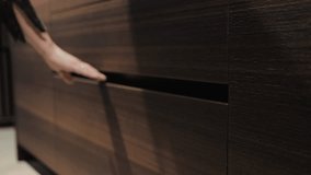 Close-up of a woman's hand opening an empty kitchen drawer. Stylish kitchen with marble countertops. Experience an elegantly designed modern drawer mechanism that aligns with your hands movement. - Powered by Shutterstock - Get 15% off with code: PIKWIZARD15