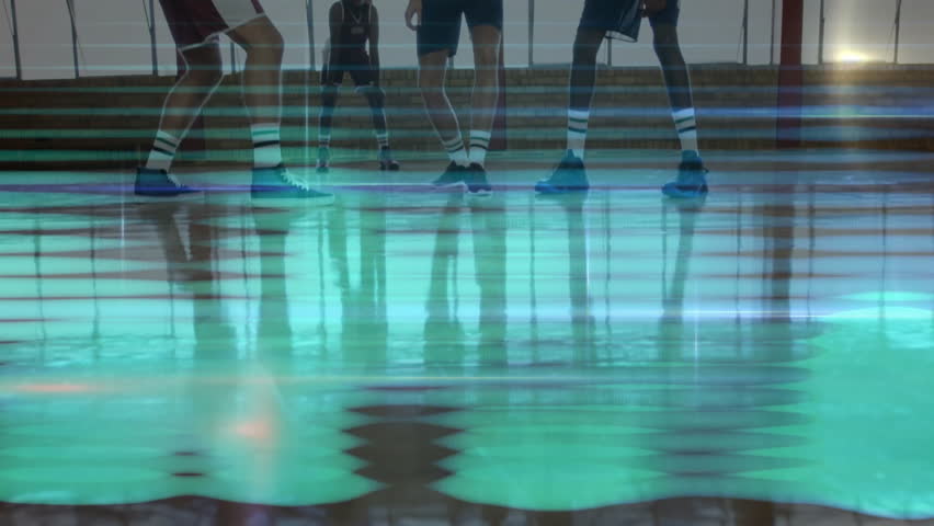 Referee bouncing basketball then tossing upward to start tip-off while players leaping on court. Athletics, sports, competition, energetic, gymnasium, teamwork, dynamic