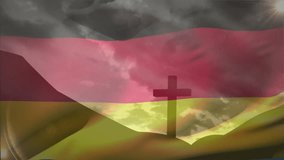 Wind blowing, German flag waving over cross on hill, clouds drifting, unveiling glowing horizon. Patriotism, landscape, symbolism, serenity, motion, natural, dramatic - Powered by Shutterstock - Get 15% off with code: PIKWIZARD15
