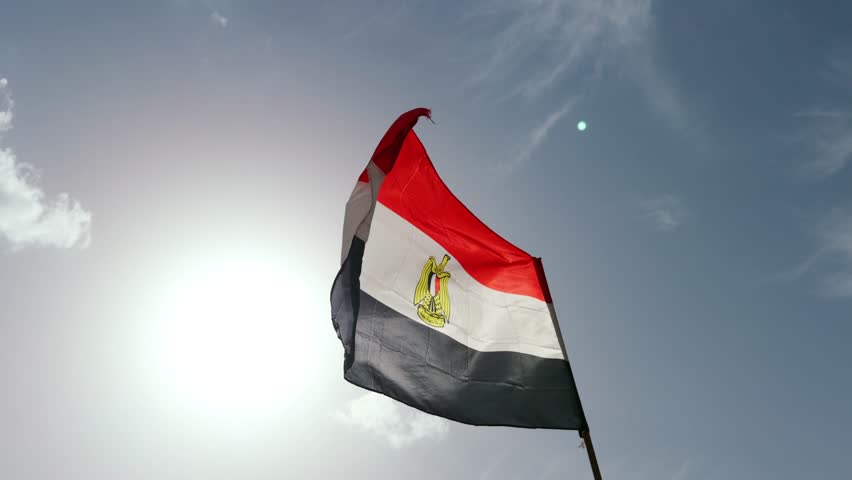 Egyptian Flag Waving with Pride Against Clear Blue Sky