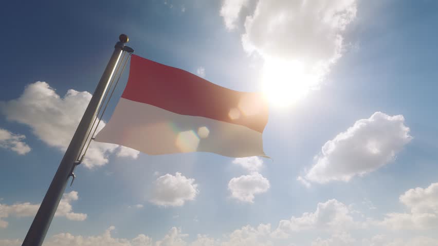 Indonesia Flag waving on a Flagpole with a cloudy blue sky background