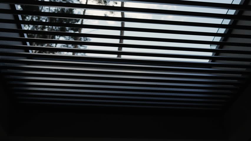 Modern balcony design in a private two-story house overlooking a forest landscape. Stylish balcony with a modern pergola. Slatted roof.