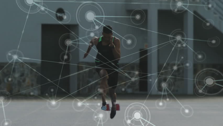 Male sprinter pushing off red starting blocks upon start signal, animating technology data network. Athlete, sprint, acceleration, technology, data, network, urban