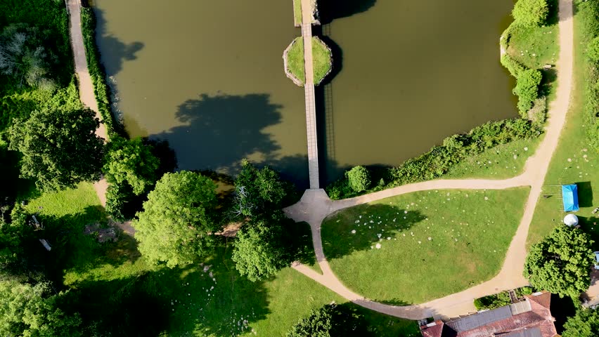 Drone-shot footage of Bodiam Castle offers timeless visuals for creators. Epic, cinematic overhead view of castle, bridge walk and moat.