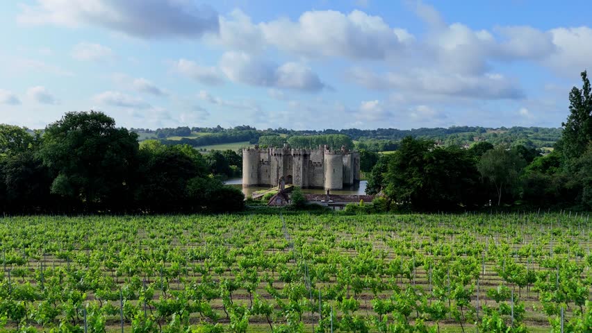 Experience the breathtaking flight over fields leading to Bodiam Castle. Aerial footage ideal for historical films, documentaries, and cinematic projects.