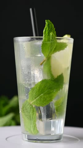 Classic Mojito Cocktail with Lime and Mint on black background	