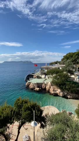 Turkish seaside landscape with turquoise sea, rocky coast, and clear blue sky video