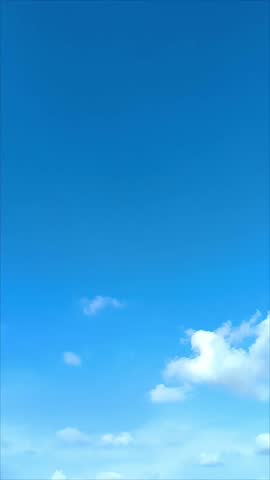 Clear Blue Sky With Minimal Clouds on a Sunny Day: A serene blue sky with minimal scattered clouds, depicting tranquility and open spaces, evoking feelings of freedom and peacefulness