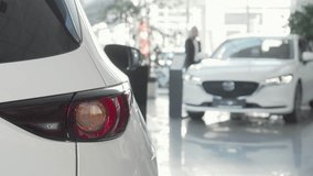 Female customer exploring automobiles at a vibrant dealership showroom - Powered by Shutterstock - Get 15% off with code: PIKWIZARD15