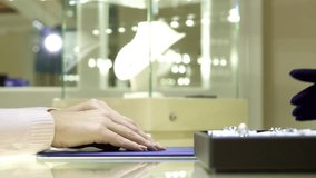 Elegant woman selecting a stunning ring at a luxurious jewelry boutique - Powered by Shutterstock - Get 15% off with code: PIKWIZARD15