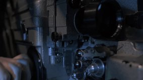 Man hand turns switch starting old 16mm film projector, movie screening. - Powered by Shutterstock - Get 15% off with code: PIKWIZARD15