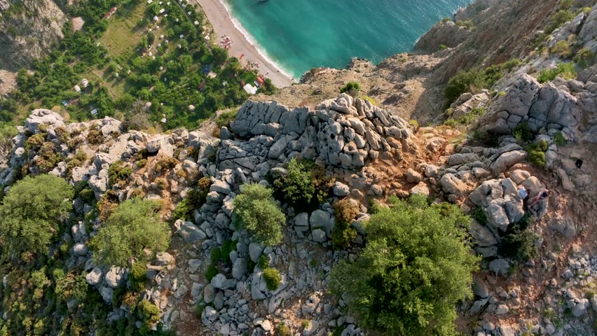 Majestic cliffs overlooking butterfly valley in turkey, revealing a breathtaking panorama of turquoise waters, sandy beach, and lush greenery