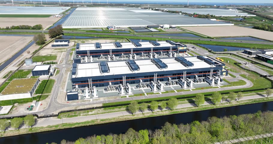 data center, server space, computing center, big tech, big data, industrial data processing, building exterior. Middenmeer, The Netherlands. Aerial video.