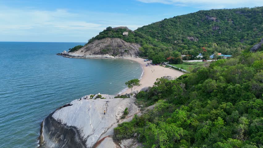 Relaxing view of empty Thai beach and green cliffs