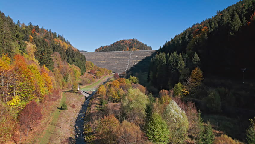 Scenic panorama of Turcek reservoir winding through colorful autumn forest and surrounded by rolling hills. 2x speeded up from 30 fps.
