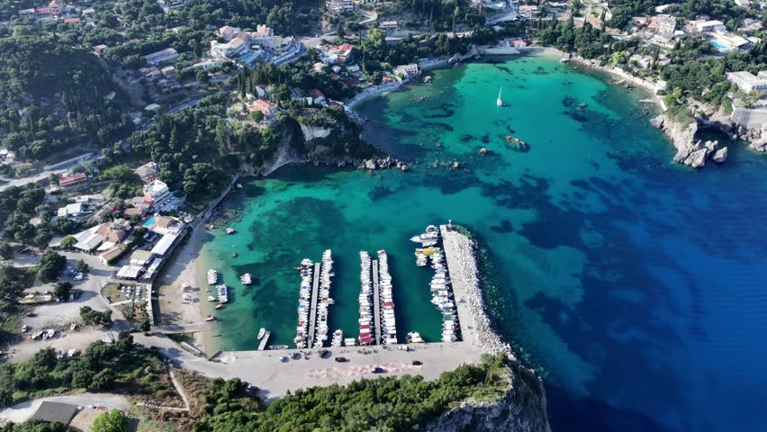 4k aerial video footage - panning up and right across area around Paleokastritsa Bay to Liapades Bay , located northwest part of Corfu, Greece, with mountain landscape in background