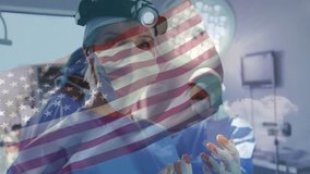 Surgeon entering medical OR starting surgery while nurse prepping tools with flag overlay. Medical, healthcare, professionalism, teamwork, precision, sterile, heroic - Powered by Shutterstock - Get 15% off with code: PIKWIZARD15