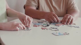 Grandmother and granddaughter doing puzzle at home. - Powered by Shutterstock - Get 15% off with code: PIKWIZARD15