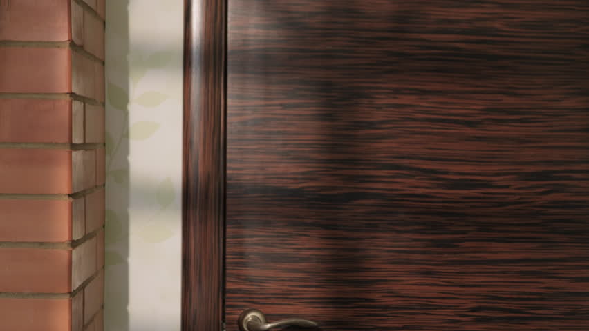 Woman opens closed door to room and looks around