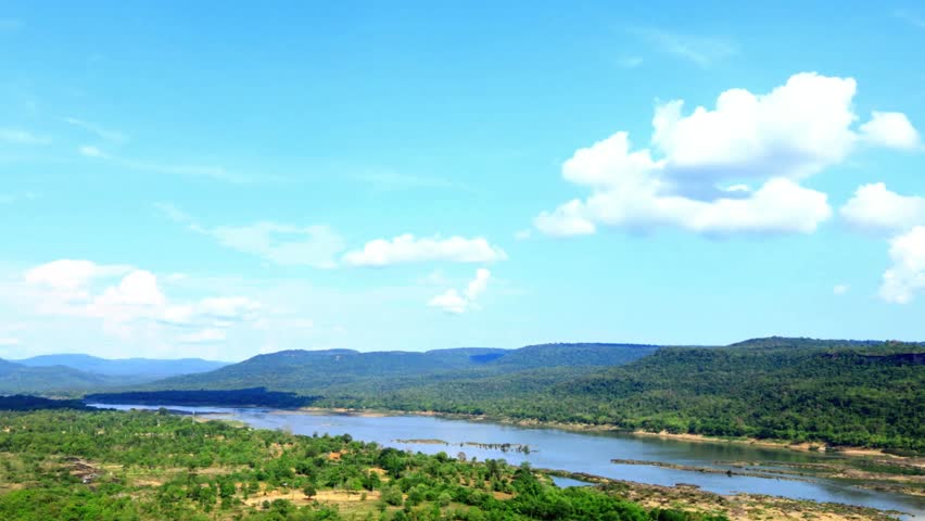 Serene River Landscape with Blue Sky and Lush Green Hills