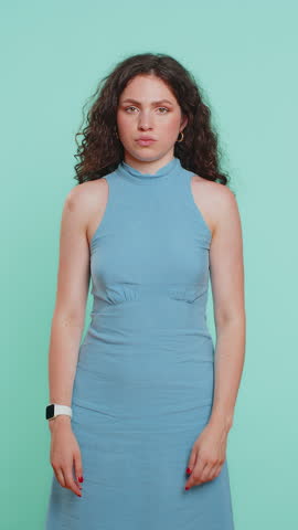 I cant hear you. What. Young woman trying hear you, looking confused and frowning, keeping arm near ear for louder voice, asking to repeat, to hear information, deafness. Pretty adult girl. Vertical