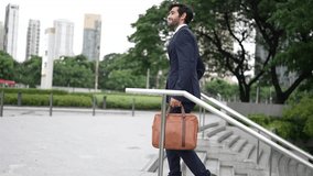 Skilled business man walking up stairs at park or city while holding bag in the hand Professional project manager going to workplace. Represent growth, getting promotion, increasing skill. Exultant. - Powered by Shutterstock - Get 15% off with code: PIKWIZARD15
