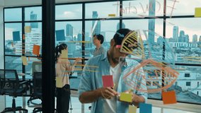Professional businessman uses sticky notes at glass wall with graph to brainstorming idea while multicultural businesspeople discussing about marketing ideas at office with city view. Tracery - Powered by Shutterstock - Get 15% off with code: PIKWIZARD15