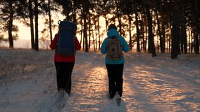 Active people vacation, healthy lifestyle, achievement. Winter expedition teamwork. Hike of successful tourist heading for success adventure. Tourist with backpack walks through snowy forest, sunset - Powered by Shutterstock - Get 15% off with code: PIKWIZARD15