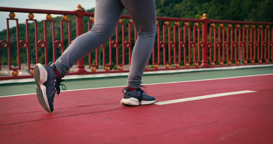 Young Sporty Woman Runner is Training in Morning. Slim Fitness Girl is Jogging outdoor. Concept of Workout Running and Healthy Sport Lifestyle.