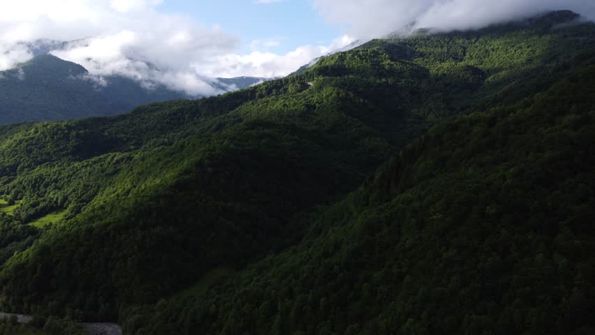 top view of foggy mountains with river and roadway 
