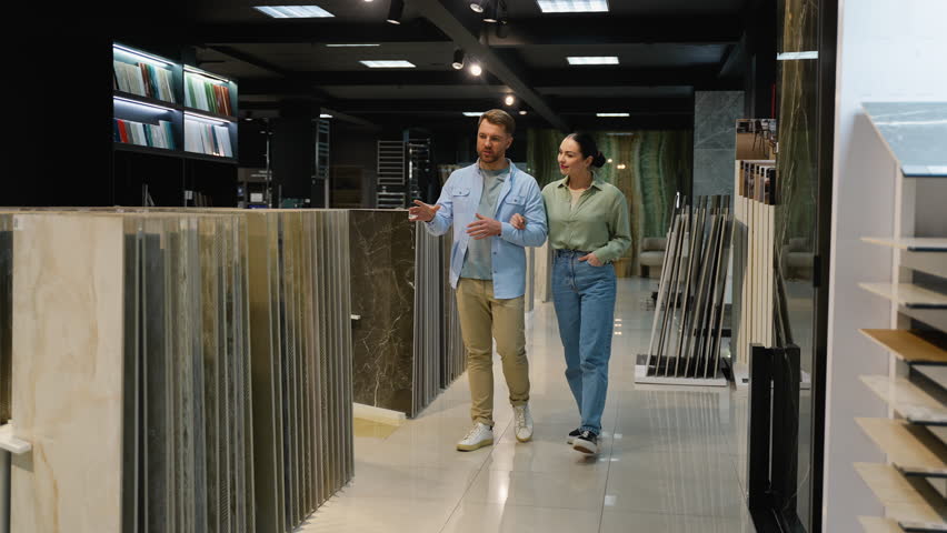 Couple choosing tiles with interior designer in showroom