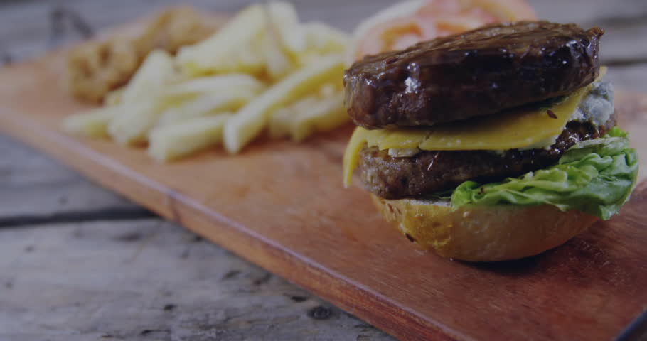 After 1s burger and fries sitting on wood board with social icons accumulating showing engagement. Fastfood, casual, vibrant, digital, marketing, promotion, trendy