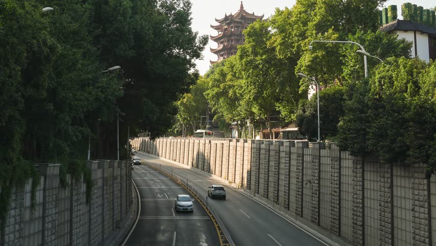 Traffic timelapse of Wuhan road tunnel with view of Yellow Crane Tower, China - tourist attractions and ancient architecture nearby
