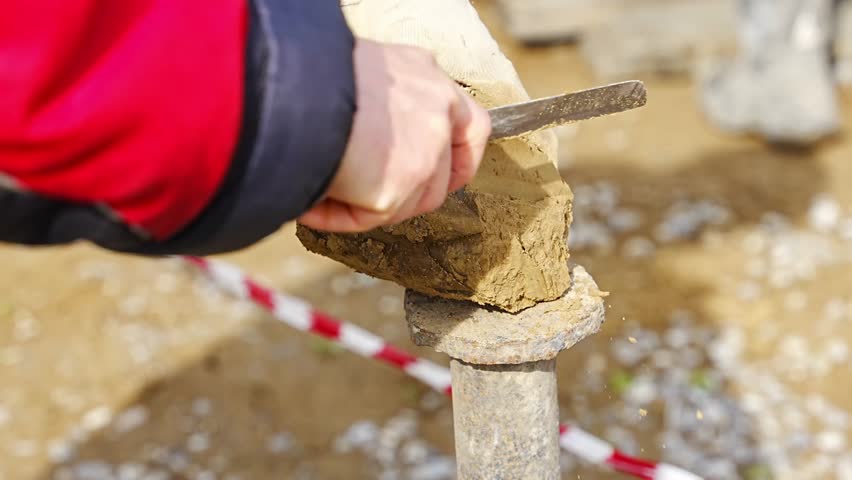 Man cutting and cleaning soil sample for laboratory analysis. Preparation of core material for geotechnical testing and scientific evaluatio. High quality 4k footage
