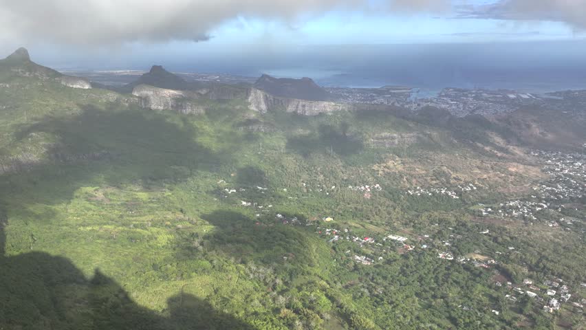 Aerial view of the majestic Pieter Both mountain with lush greenery and dramatic clouds, Port Louis, Mauritius.