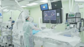 Lens blurred view, a heart surgery process, professional surgeons and medical team at work, coronary angiography of the heart, operating room of a modern hospital, out of focus. - Powered by Shutterstock - Get 15% off with code: PIKWIZARD15