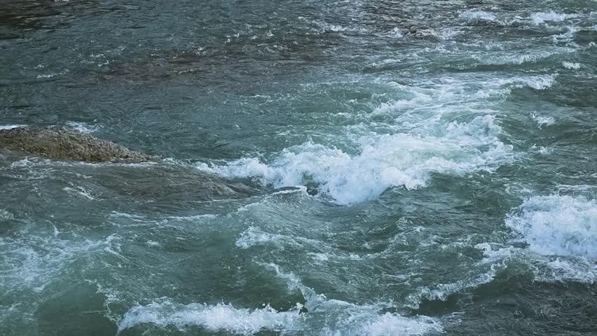 Gentle flow of river water in a slow motion