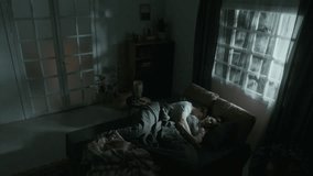Wide angle shot of man and woman sleeping in bed under eerie moonlight when doors opening and furniture start moving on its own scaring couple by paranormal phenomena in apartment at late night - Powered by Shutterstock - Get 15% off with code: PIKWIZARD15
