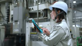 A female worker inspecting factory machinery with a tablet - Powered by Shutterstock - Get 15% off with code: PIKWIZARD15