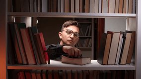 Librarian showing rosary beads and wooden cross in library bookshelf - Powered by Shutterstock - Get 15% off with code: PIKWIZARD15