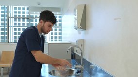 Nurse carefully washing hands in hospital sink slow motion - Powered by Shutterstock - Get 15% off with code: PIKWIZARD15
